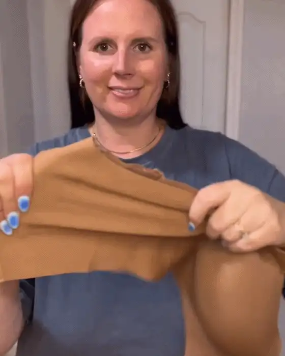 Wide straps and side panels shown on a customer trying the bra on